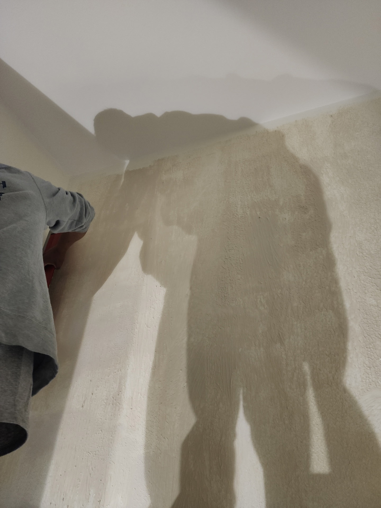 Venetian plaster being applied to powder room wall — multiple layers creating depth and texture