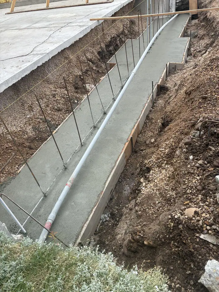 New concrete footings and foundation wall for a garage addition in Francis, Utah
