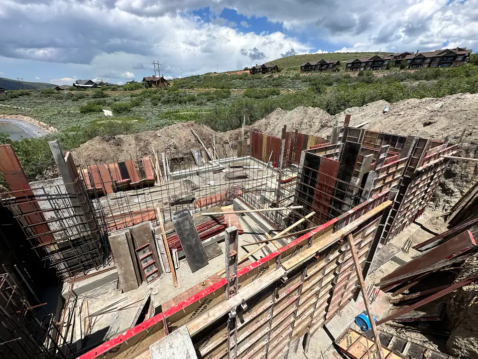 Concrete foundation formwork with rebar grid, engineered foundation system for mountain terrain