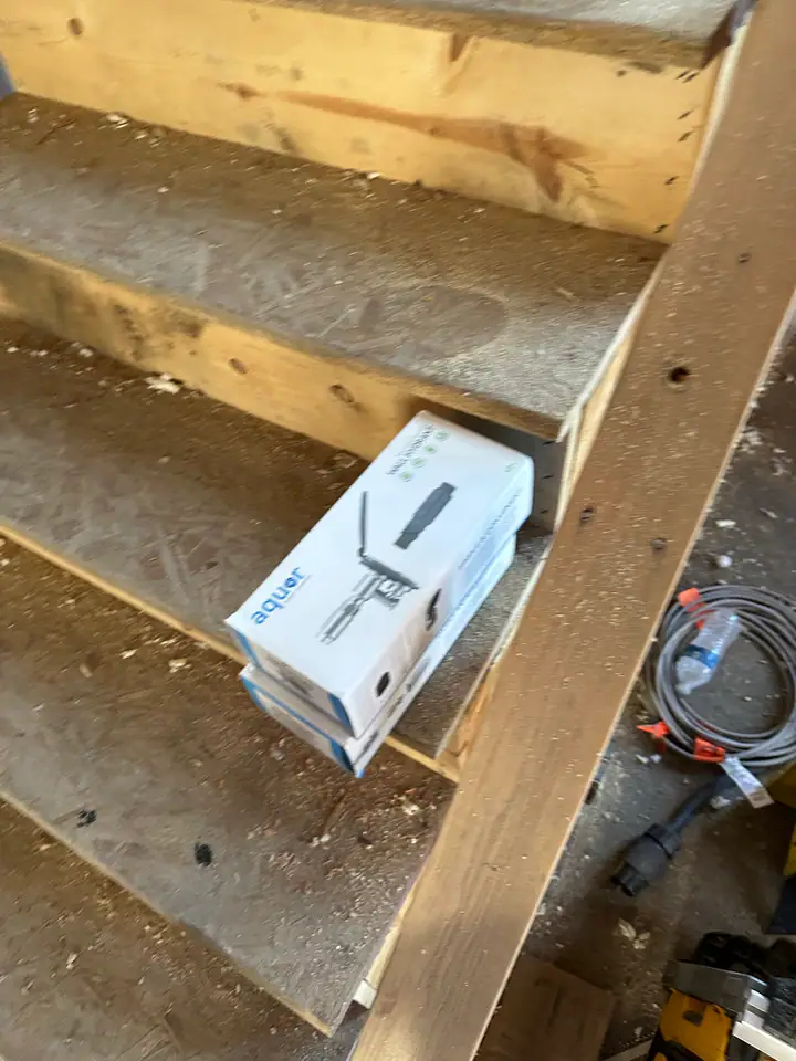 New staircase construction with solid stringers and OSB treads, connecting original main level to new second story addition