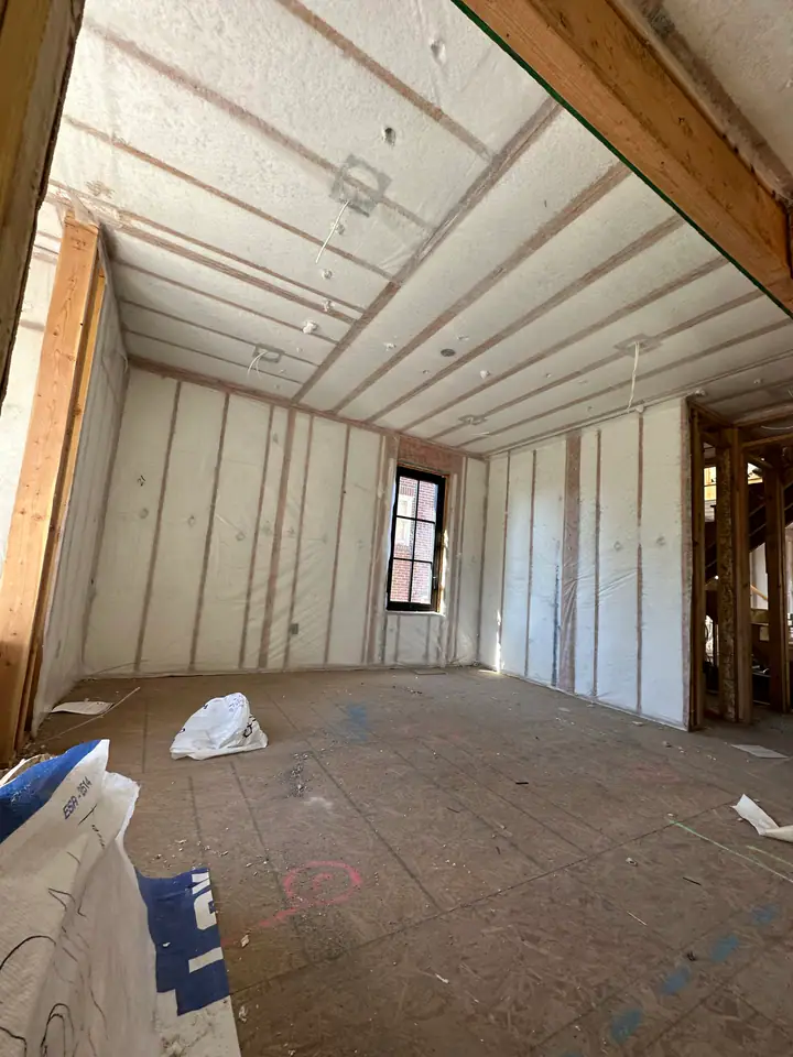 Closed-cell spray foam insulation covering walls and vaulted ceiling, complete thermal envelope in the new addition, high-performance building science