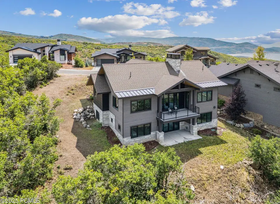 Finished custom home rear exterior with mountain backdrop