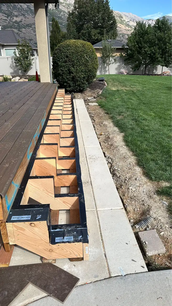 New deck framing and stair stringers along the back of a Pleasant Grove home