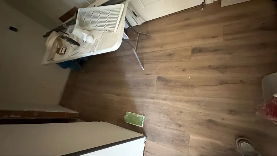 New European oak hardwood floor in a room with white walls and a window