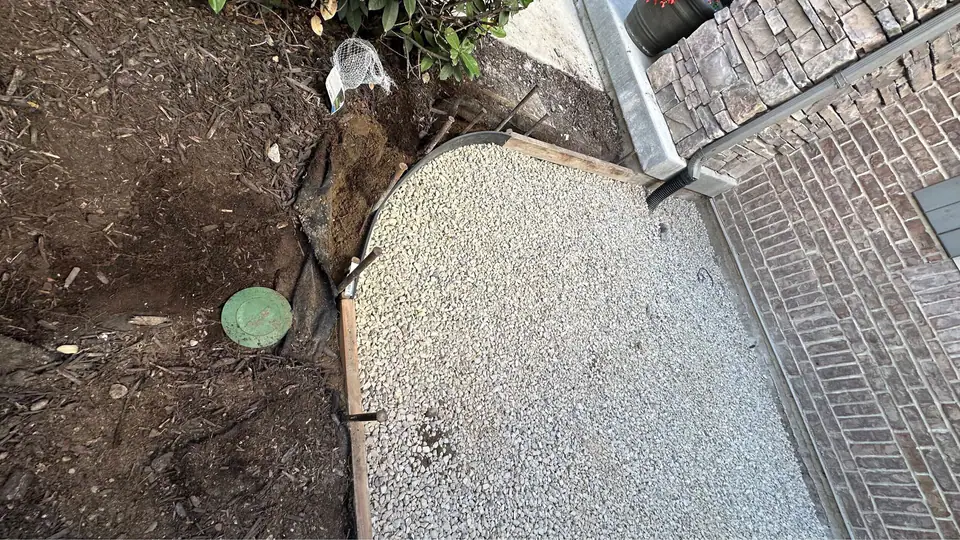 New exposed aggregate concrete patio at the front door