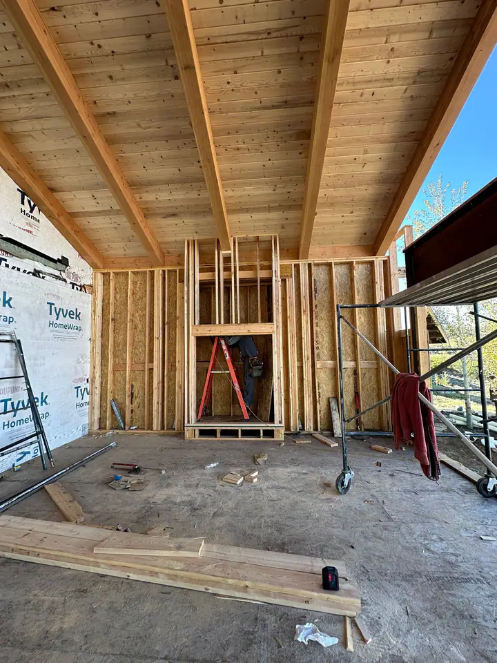 Interior framing of the addition with a scaffold and wrapped windows