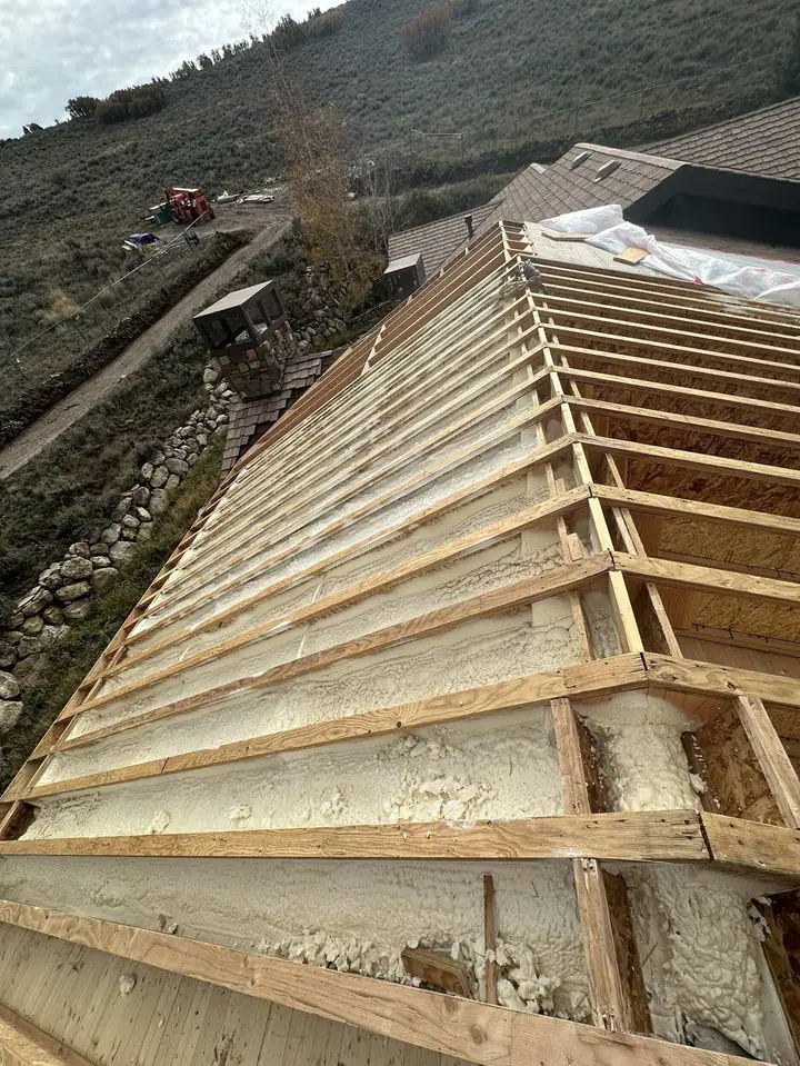 Shallow-pitch roof framing over a timber beam on a Tuhaye addition