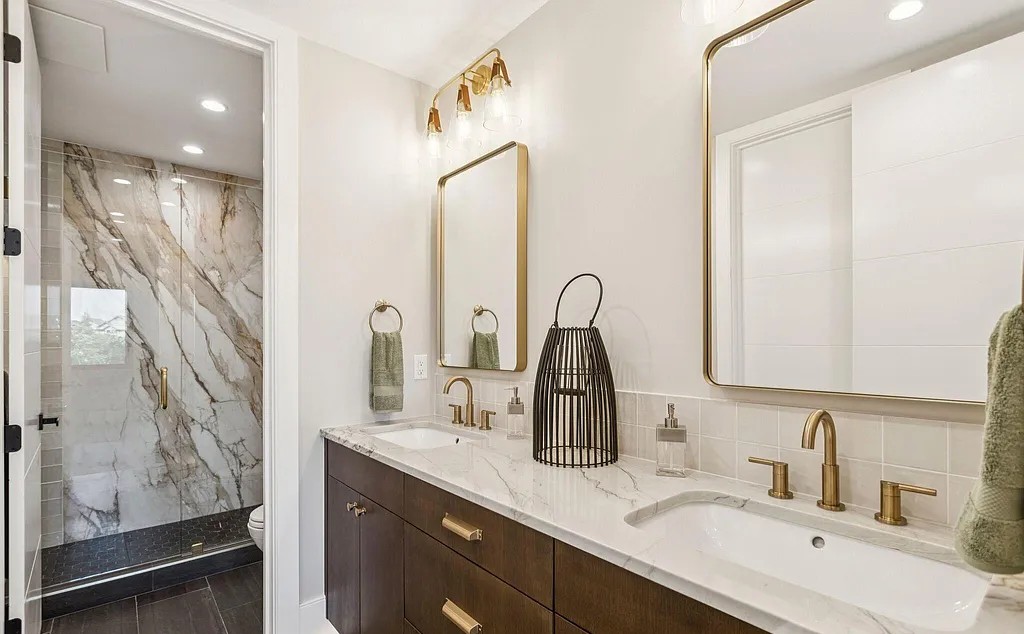 Master bathroom with marble counters and gold fixtures